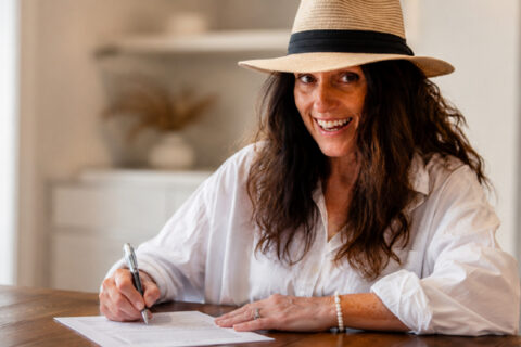 Cindy Morgan signs her distribution agreement with Syntax Creative.