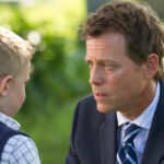 A father speaks with his young son outdoors in a scene from “Heaven Is for Real.”