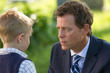 A father speaks with his young son outdoors in a scene from “Heaven Is for Real.”