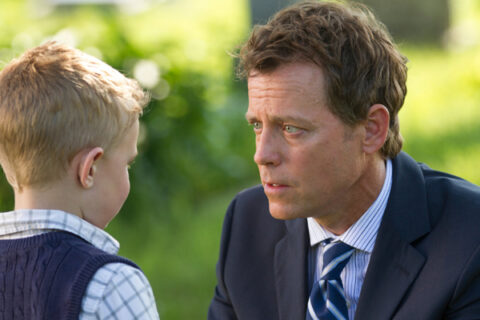 A father speaks with his young son outdoors in a scene from “Heaven Is for Real.”