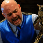 Jamie Coots handling a venomous snake during a church service