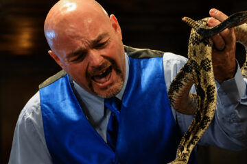 Jamie Coots handling a venomous snake during a church service