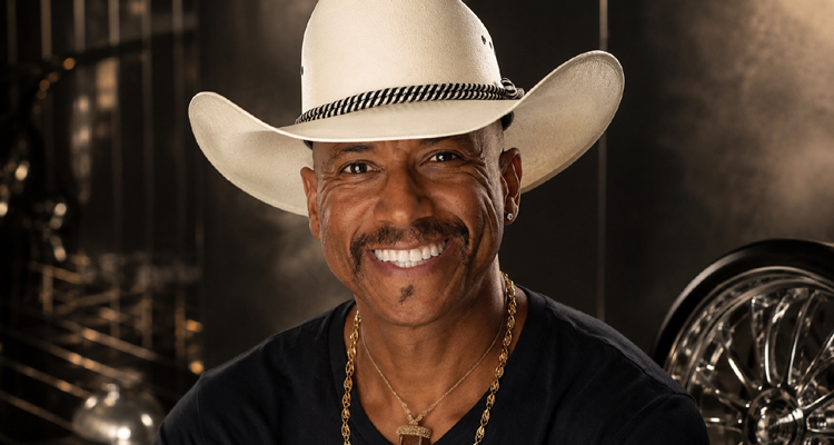 Knolly Williams in a cowboy hat with a glossy late-1990s rap-inspired backdrop.