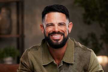 Steven Furtick smiling in an olive green jacket.