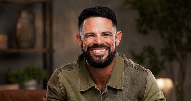 Steven Furtick smiling in an olive green jacket.