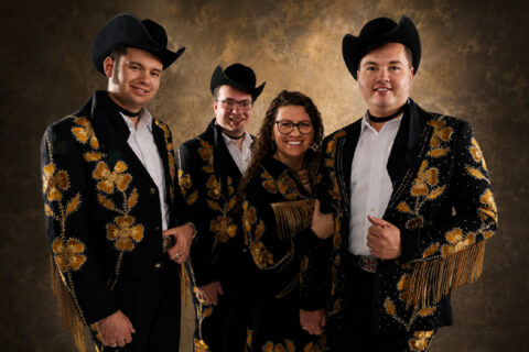 The Kody Norris Show wearing coordinated black-and-gold stage outfits.