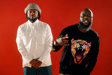 Pettidee and Knowdaverbs standing together as Village KNG against a red background.