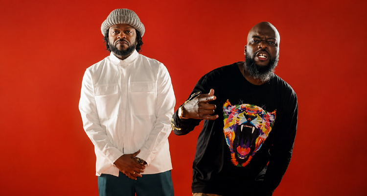 Pettidee and Knowdaverbs standing together as Village KNG against a red background.