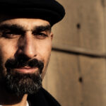 Joseph “DJ Jab” Abajian wearing a black cap and looking toward the camera.